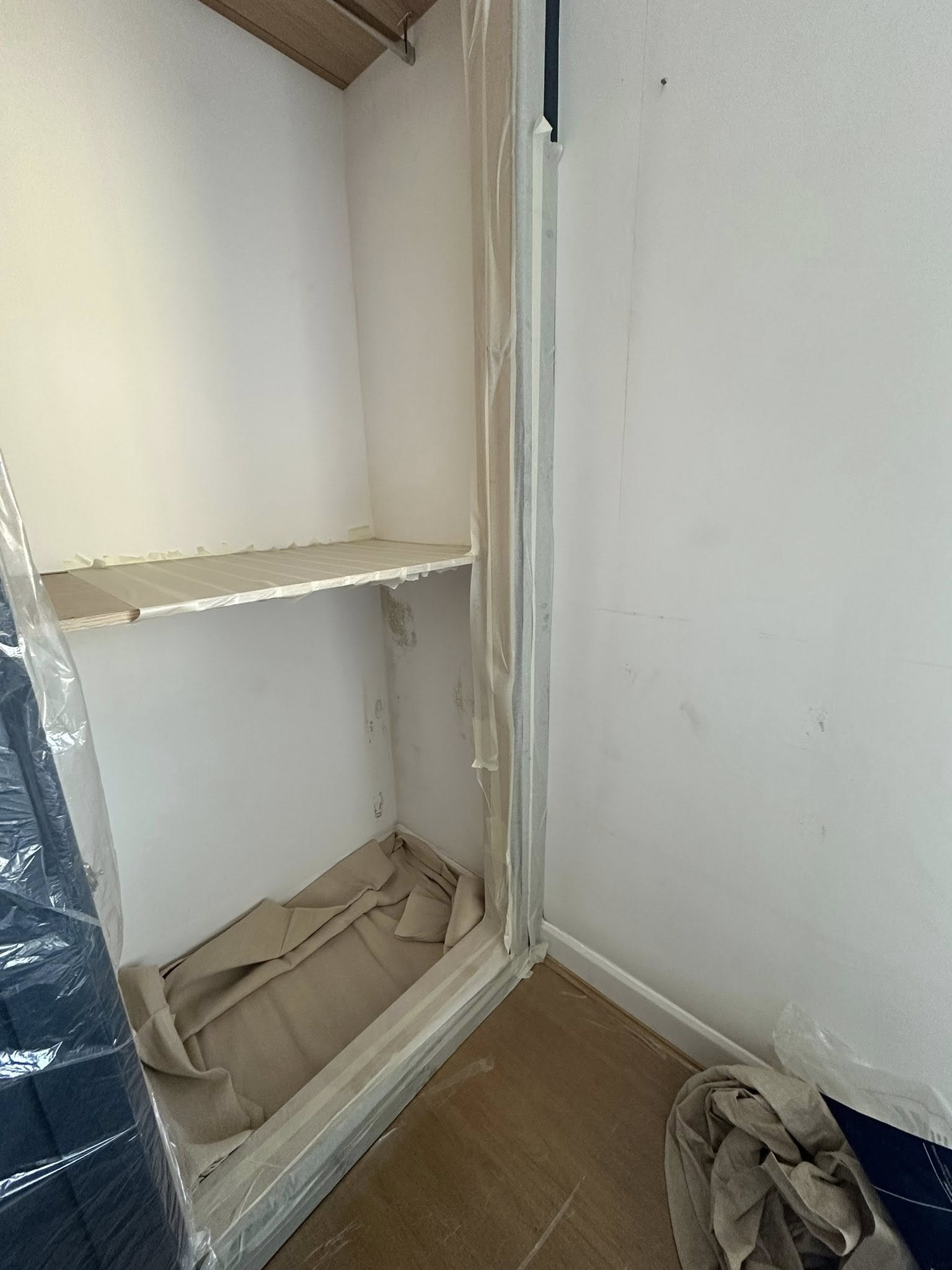 Empty room with protective plastic sheeting during renovation