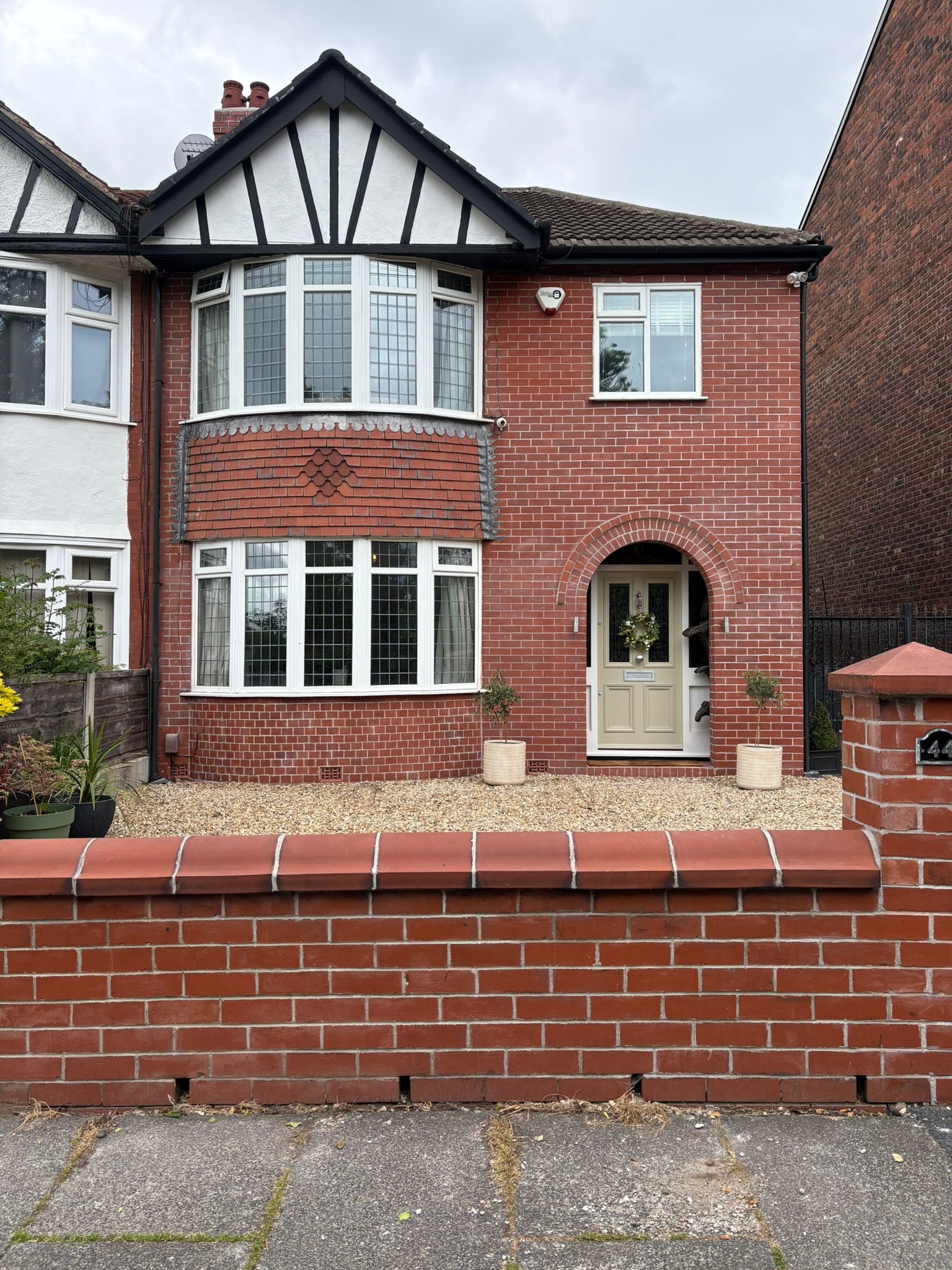 Red brick semi-detached house with bay window