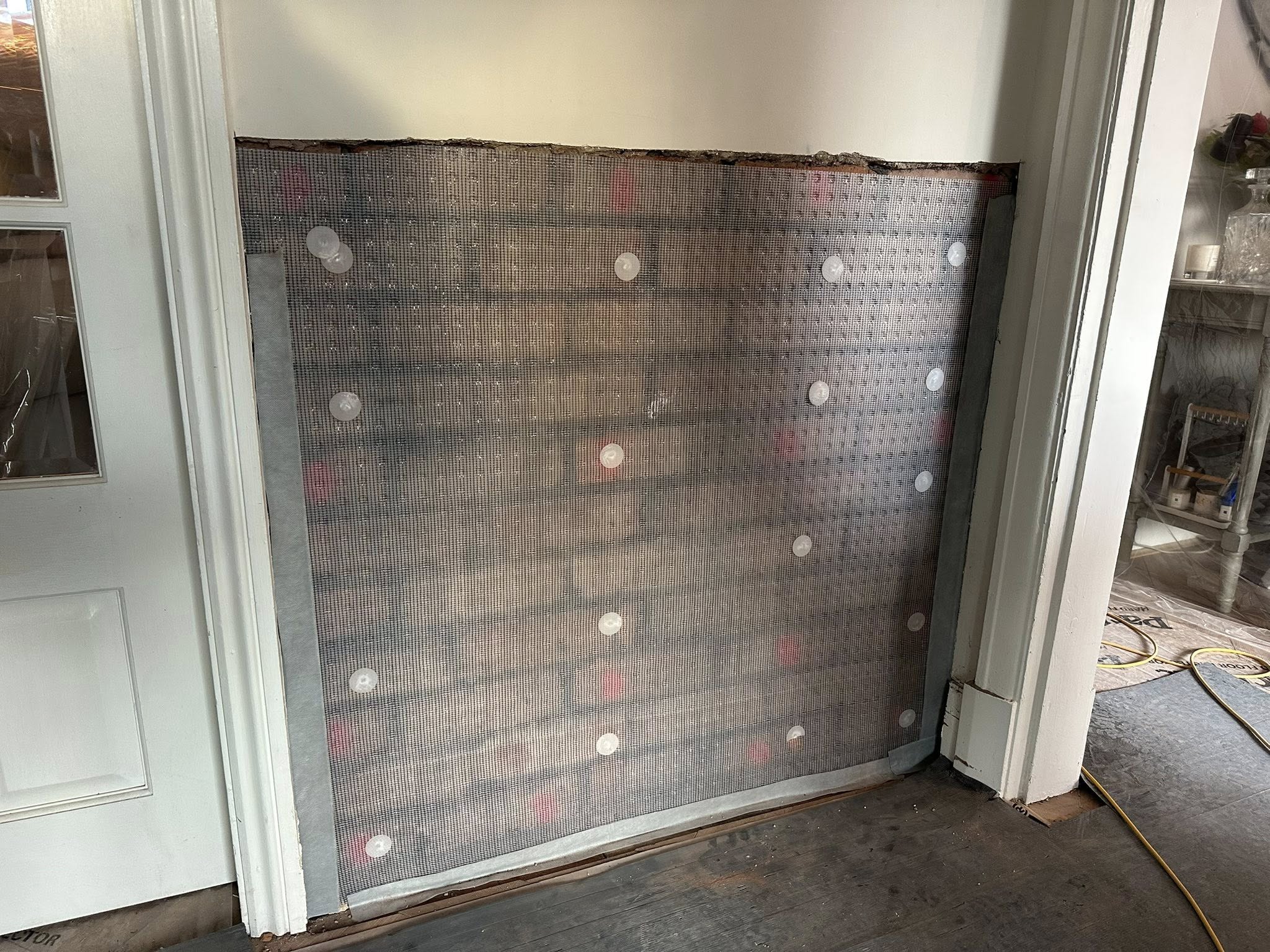 Damp proofing membrane installed on internal brickwork with anchor fixings