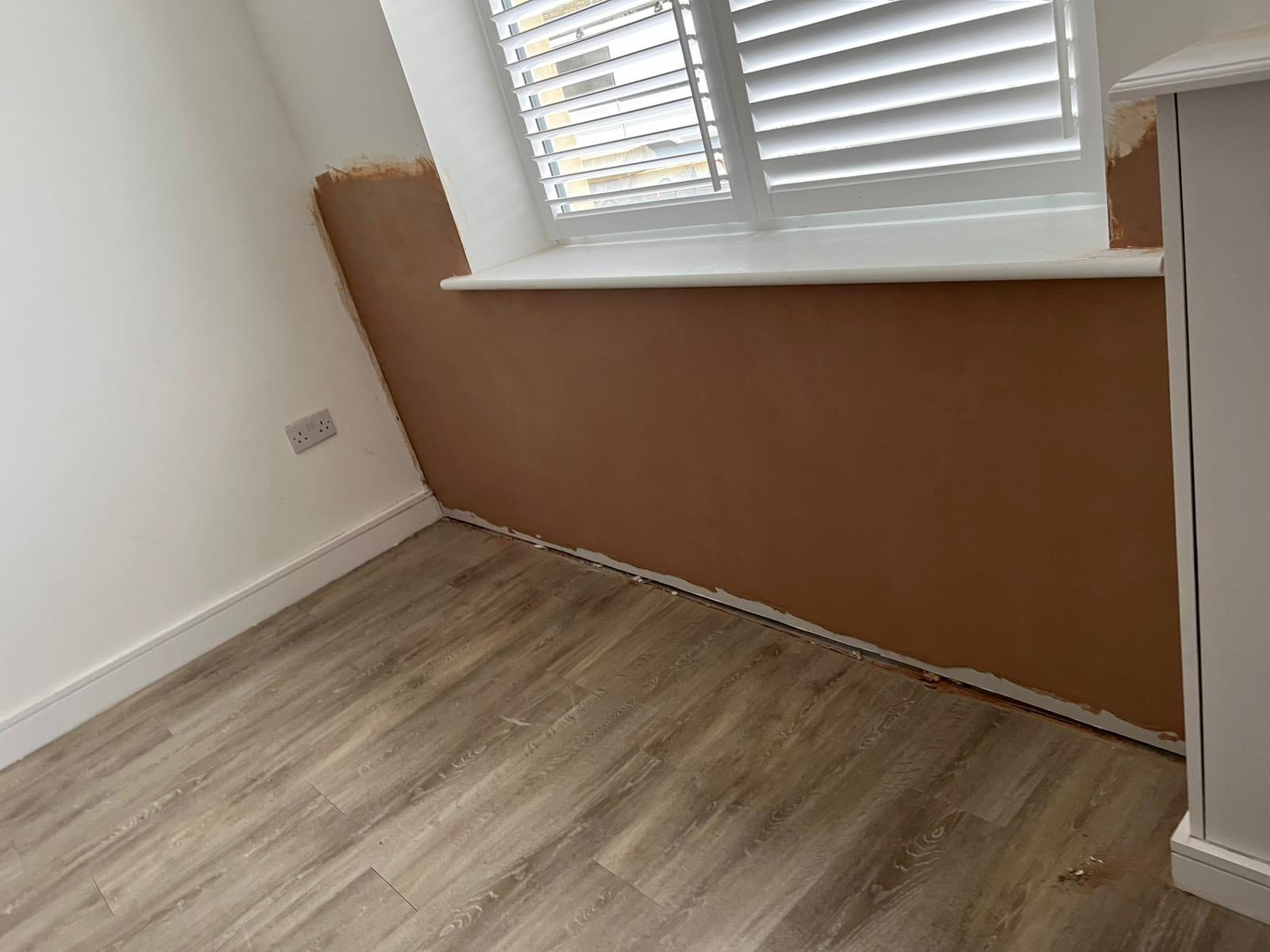 Empty room with protective cardboard wall covering