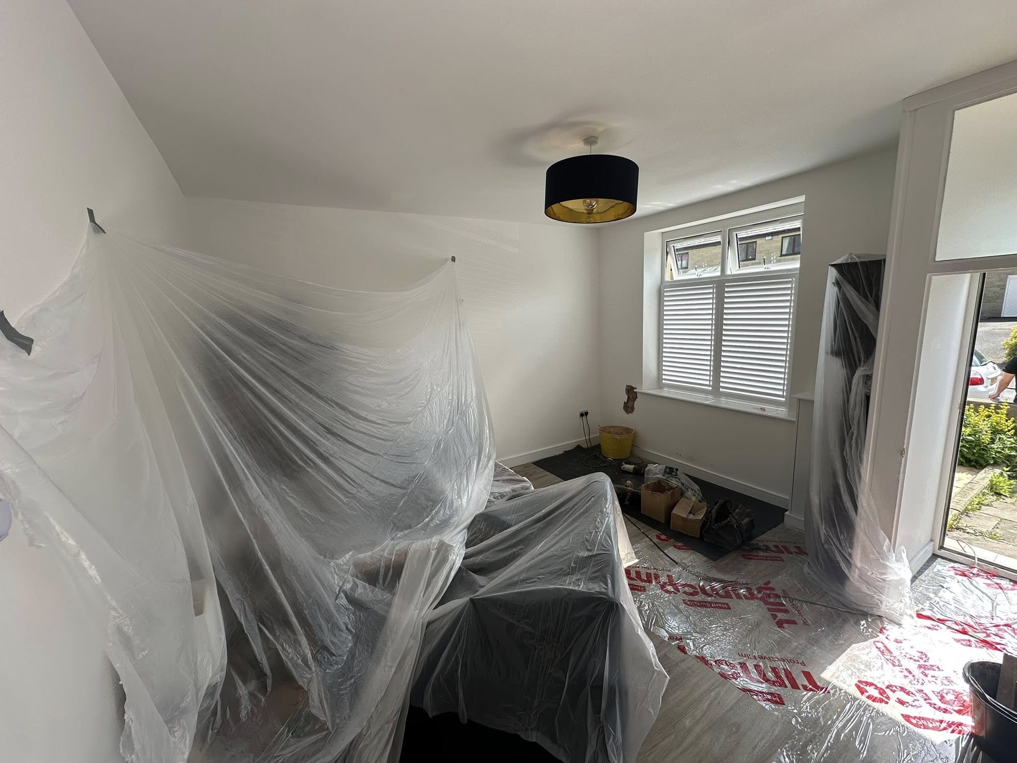 Interior room prepared with protective plastic sheeting